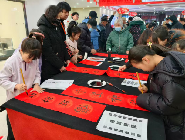 “一老一小”齐挥毫，太原尖草坪街道龙城花园社区把年味和福气送